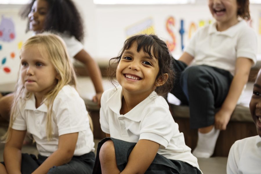 Happy girl in school uniform